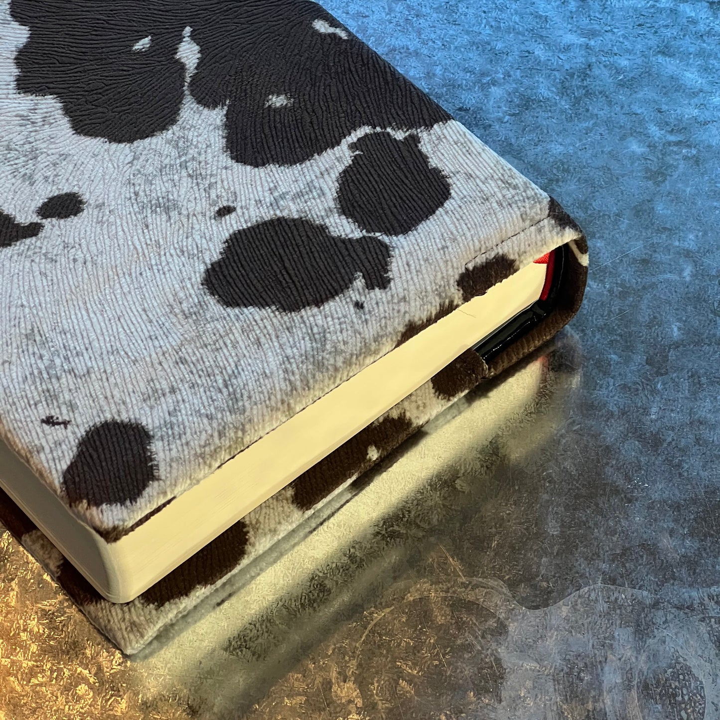 REDEEMED BARE BLACK COW PRINT BIBLE COVER